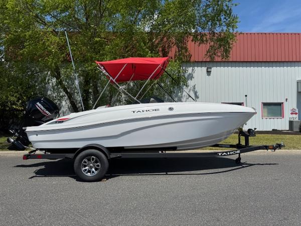 Tahoe T18 2025 Tahoe T18 boat with red canopy on trailer, parked outdoors.