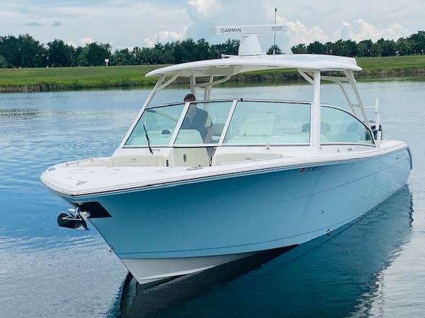 Cobia 330 Dual Console 2021 Cobia 330 Dual Console boat on a calm lake.