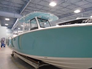 Sportsman Open 302 Center Console 2024 Sportsman Open 302 Center Console boat in a showroom, featuring a sleek blue design.