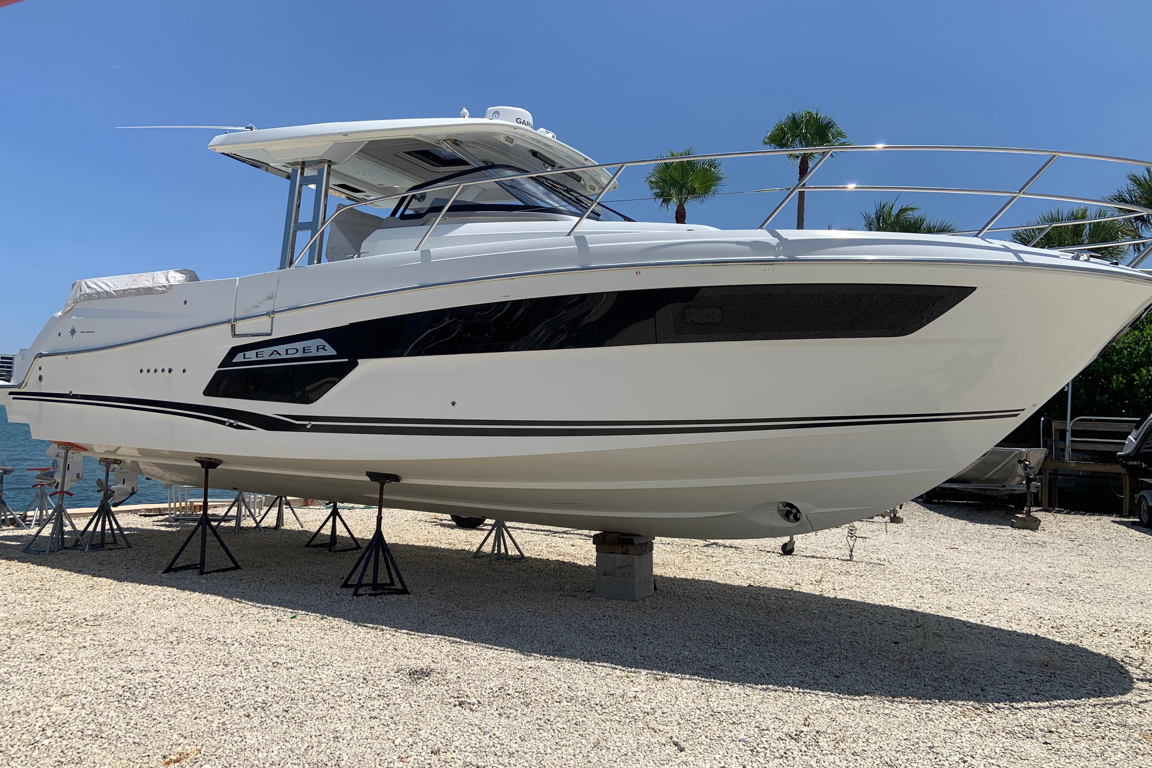 Jeanneau Leader 12.5 WA 2021 Jeanneau Leader 12.5 WA boat on stands, displayed outdoors under clear blue sky.