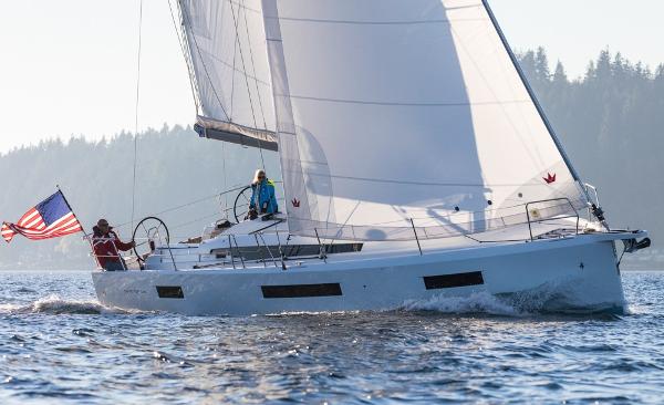 Jeanneau Sun Odyssey 440 2025 Jeanneau Sun Odyssey 440 sailing on open water with American flag.