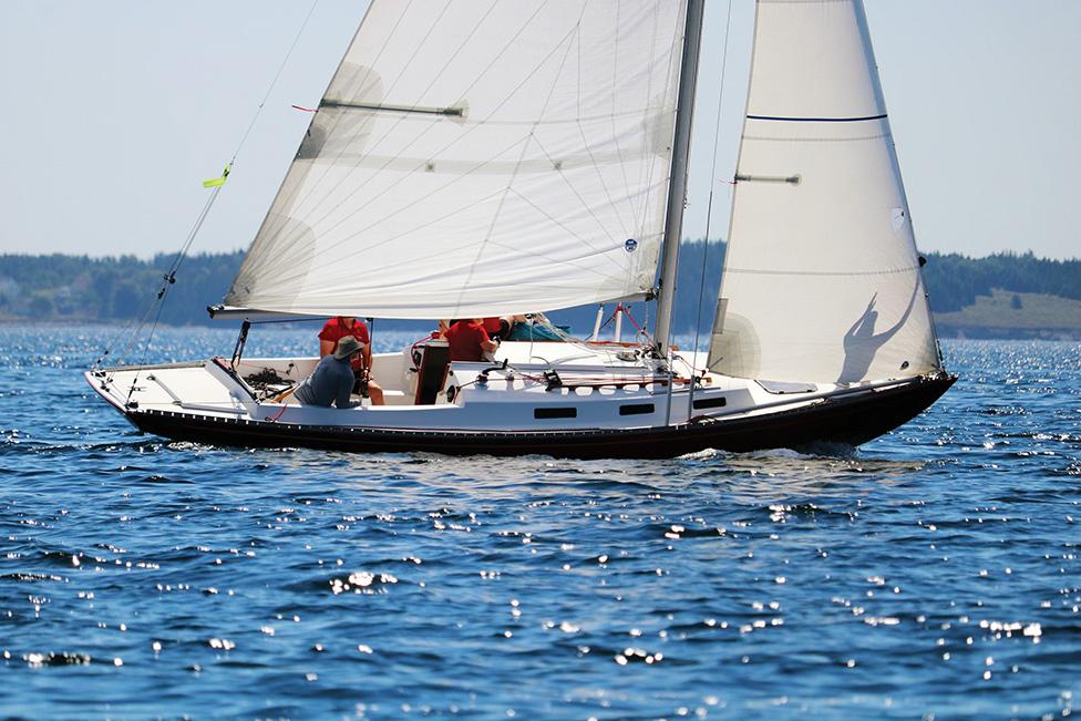 Custom Roue 20 Sailboat "Custom Roue 20" from 1980 gliding on calm blue waters.