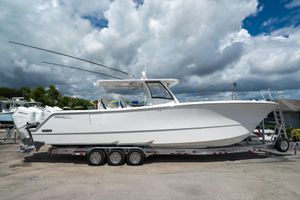 Front Runner 37 Catamaran 2026 Front Runner 37 Catamaran on trailer under cloudy sky.