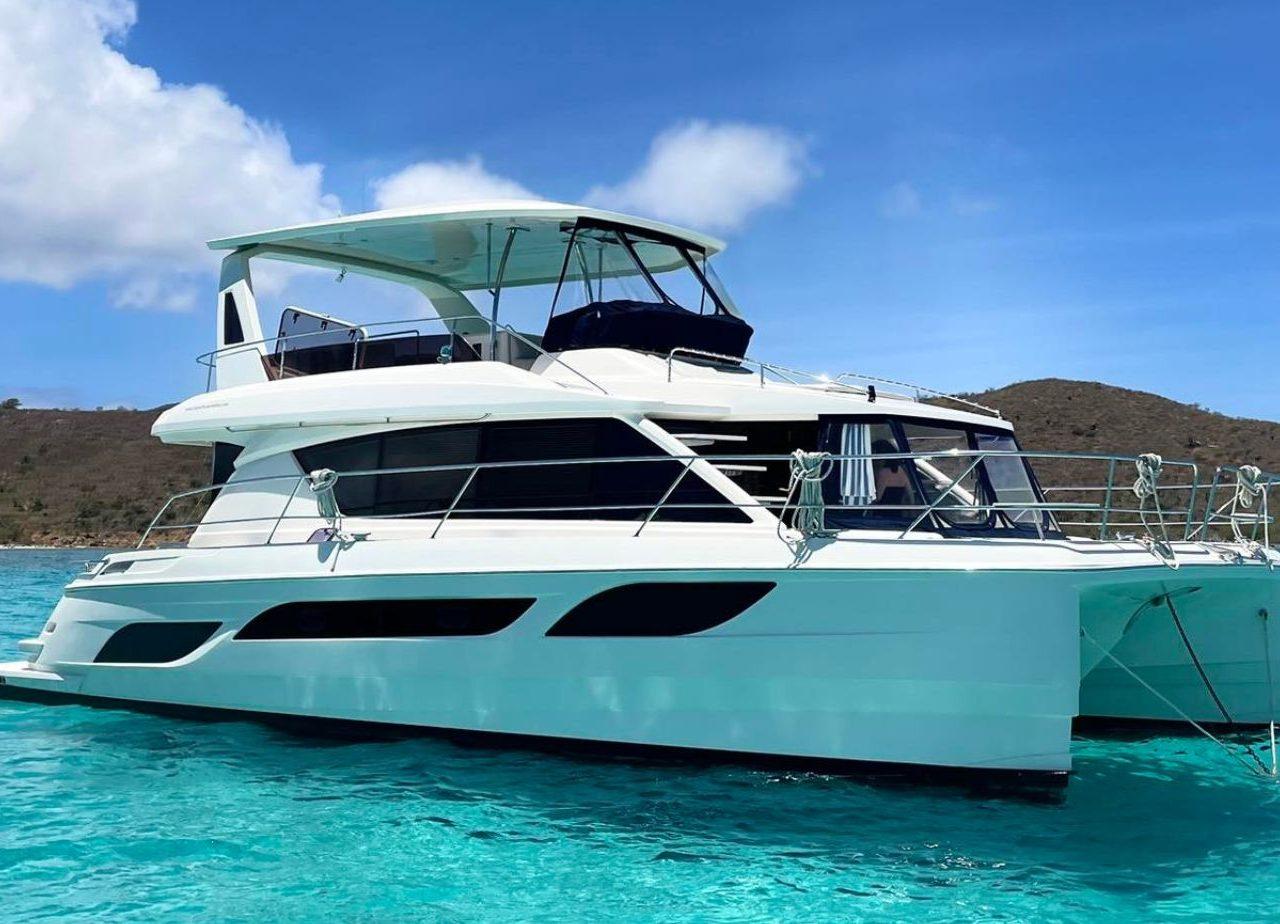 Aquila 48 Aquila 48 yacht from 2016 on clear turquoise water under a blue sky.