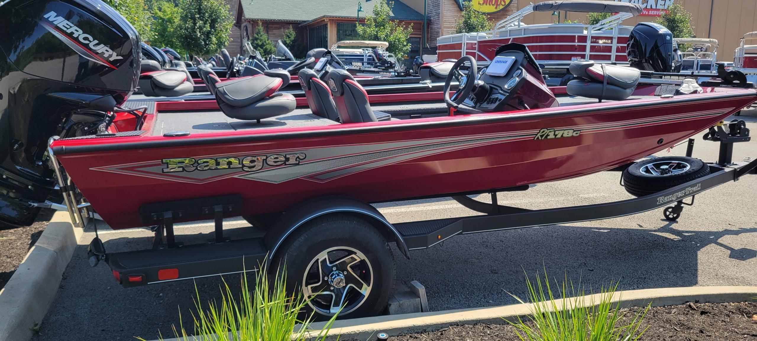 Ranger RT178C 2025 Ranger RT178C fishing boat in red, displayed on a trailer in a parking lot.