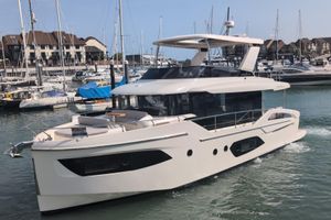 Absolute Navetta 53 2025 Absolute Navetta 53 yacht docked in a marina, showcasing sleek design and luxury features.