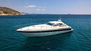 Pershing 52 Hard Top / Turn Key Condition !!! 2002 Pershing 52 Hard Top yacht on clear blue sea, near rocky coastline.