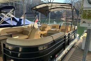 Crest 220 CREST II 2019 Crest 220 CREST II pontoon boat docked on a serene lake.