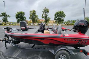Nitro Z17 2026 Nitro Z17 boat with Mercury Pro XS engine in a parking lot.