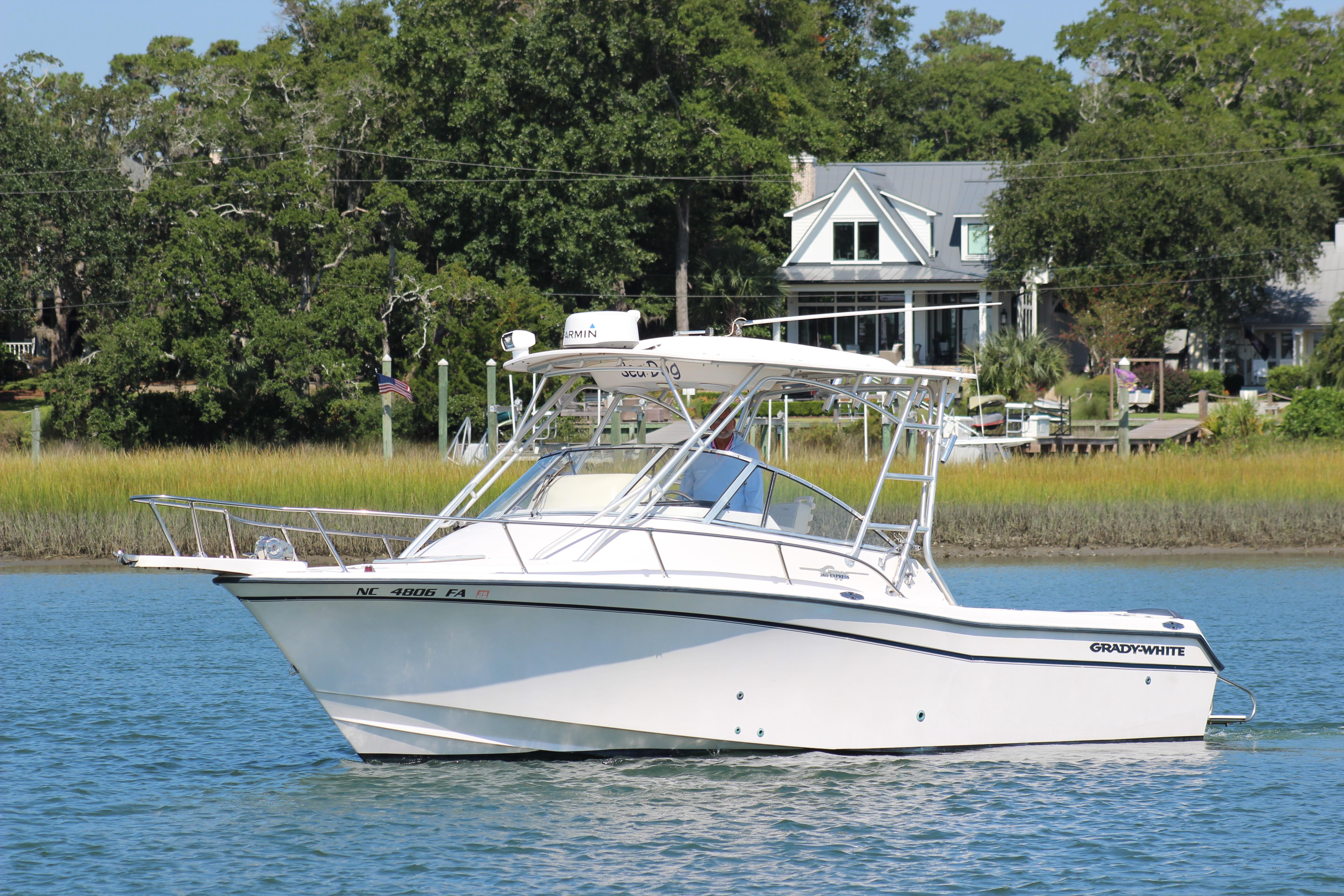 Grady-White Express 265 2001 Grady-White Express 265 boat on calm water near a scenic shoreline.
