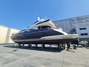 Azimut 98 Leonardo Azimut Leonardo 98 yacht from 2003 on dry dock, side view under clear blue sky.