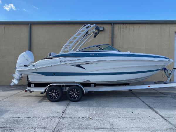 Crownline 250 XSS 2024 Crownline 250 XSS boat on a trailer, side view.