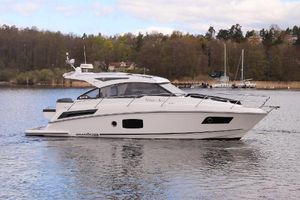 Grandezza 34 Grandezza 34 motor yacht from 2018 on a serene lake with forested background.