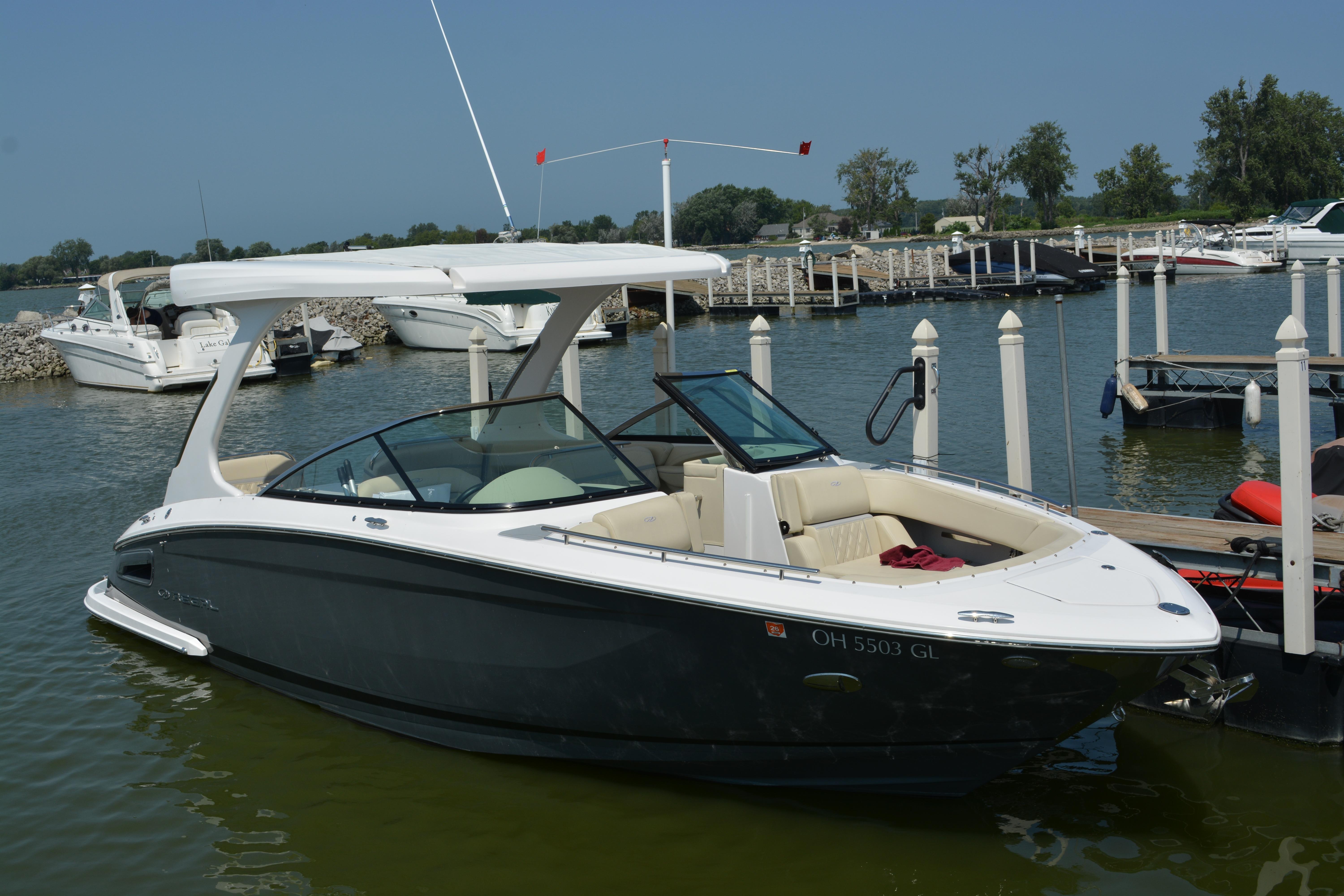 Regal 2800 Bowrider 2019 Regal 2800 Bowrider docked at a marina, featuring sleek design and spacious seating.