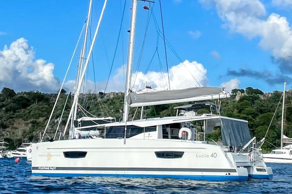 Fountaine Pajot Lucia 40 2019 Fountaine Pajot Lucia 40 catamaran sailing on a serene blue sea.