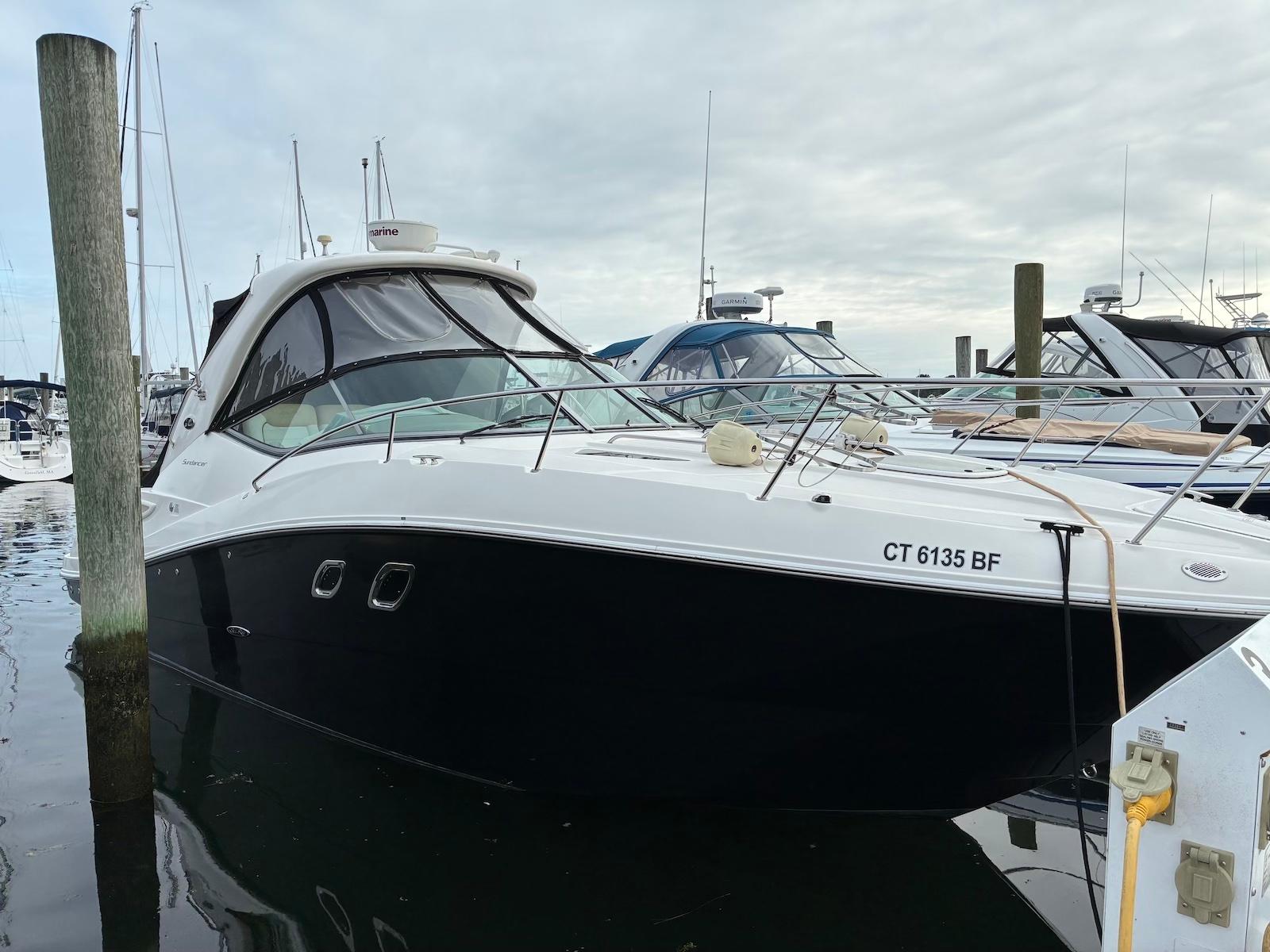 Sea Ray 330 Sundancer 2009 Sea Ray 330 Sundancer yacht docked at marina, overcast sky.