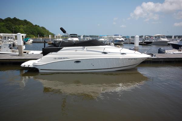 Regal 2665 Commodore 2007 Regal 2665 Commodore boat docked at marina, calm water, clear sky.