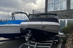 Regal 2000 ESX Bowrider 2024 Regal 2000 ESX Bowrider on trailer, parked near a building, overcast sky.