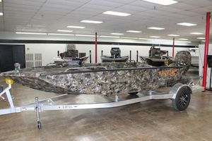 Excel Viper F4 1860 2025 Excel Viper F4 1860 boat with camouflage design on a trailer in showroom.