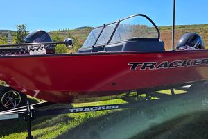 Tracker Pro Guide V-16 WT 2026 Tracker Pro Guide V-16 WT boat on trailer, red exterior, outdoors.