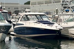 Regal 35 Sport Coupe 2013 Regal 35 Sport Coupe docked at a marina, surrounded by other boats.