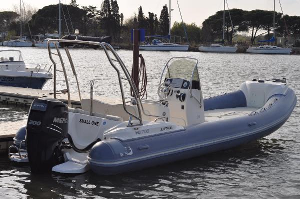 Nuova Jolly NJ 700 2017 Nuova Jolly NJ 700 boat docked with Mercury engine, calm water background.