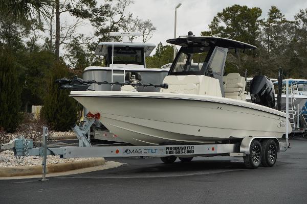 Scout 261 XSS 2025 Scout 261 XSS boat on trailer, parked outdoors.