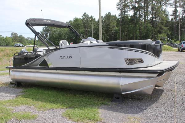 Avalon LSZ Versatile Rear Lounger 2025 Avalon LSZ Versatile Rear Lounger pontoon boat parked on gravel.