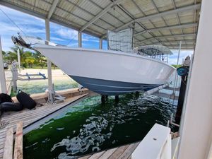 Contender 44 ST 2024 Contender 44 ST boat docked in a covered marina, elevated above water.