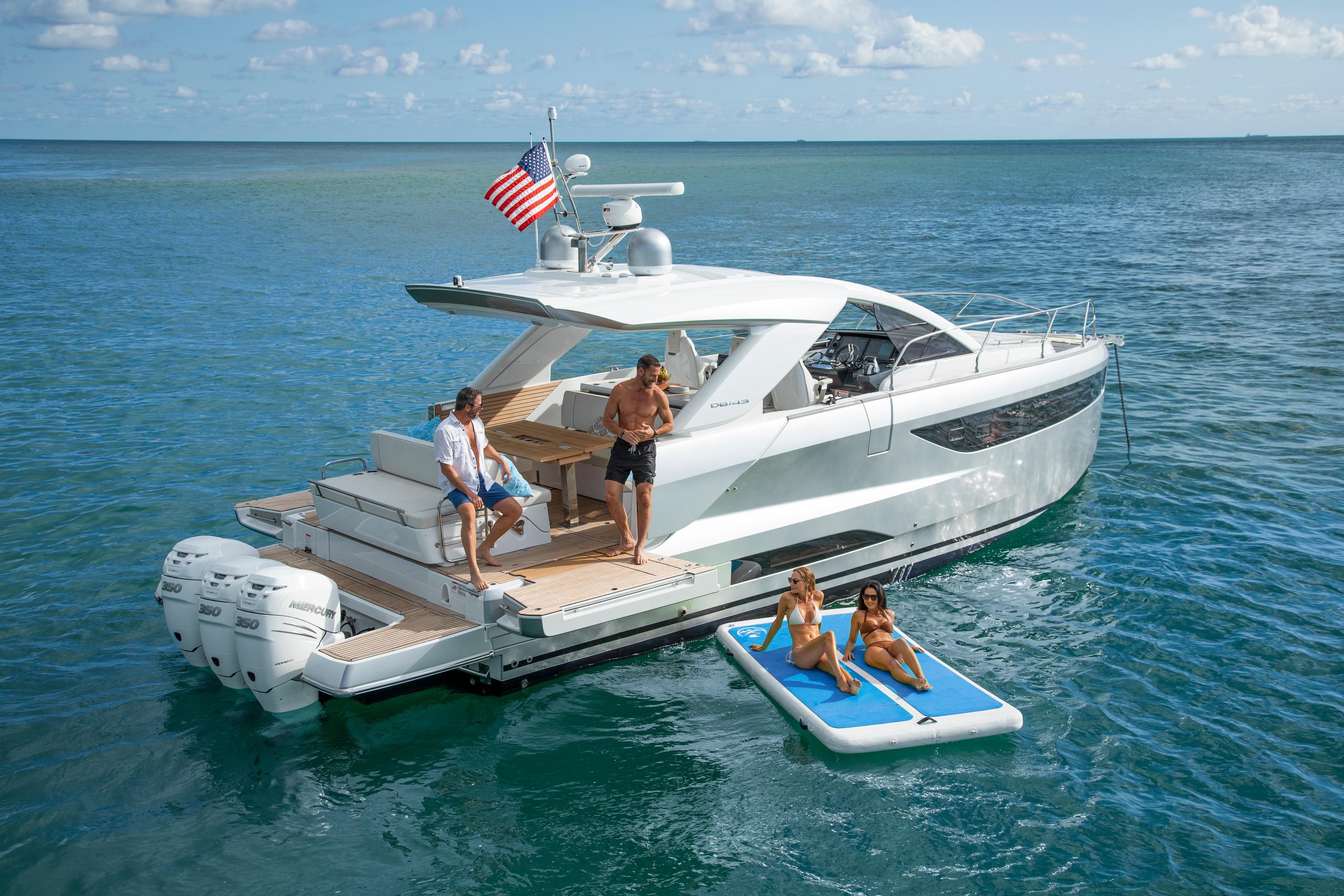 Jeanneau DB 43 OB 2026 Jeanneau DB 43 OB yacht on ocean, people relaxing on deck and floating mat.