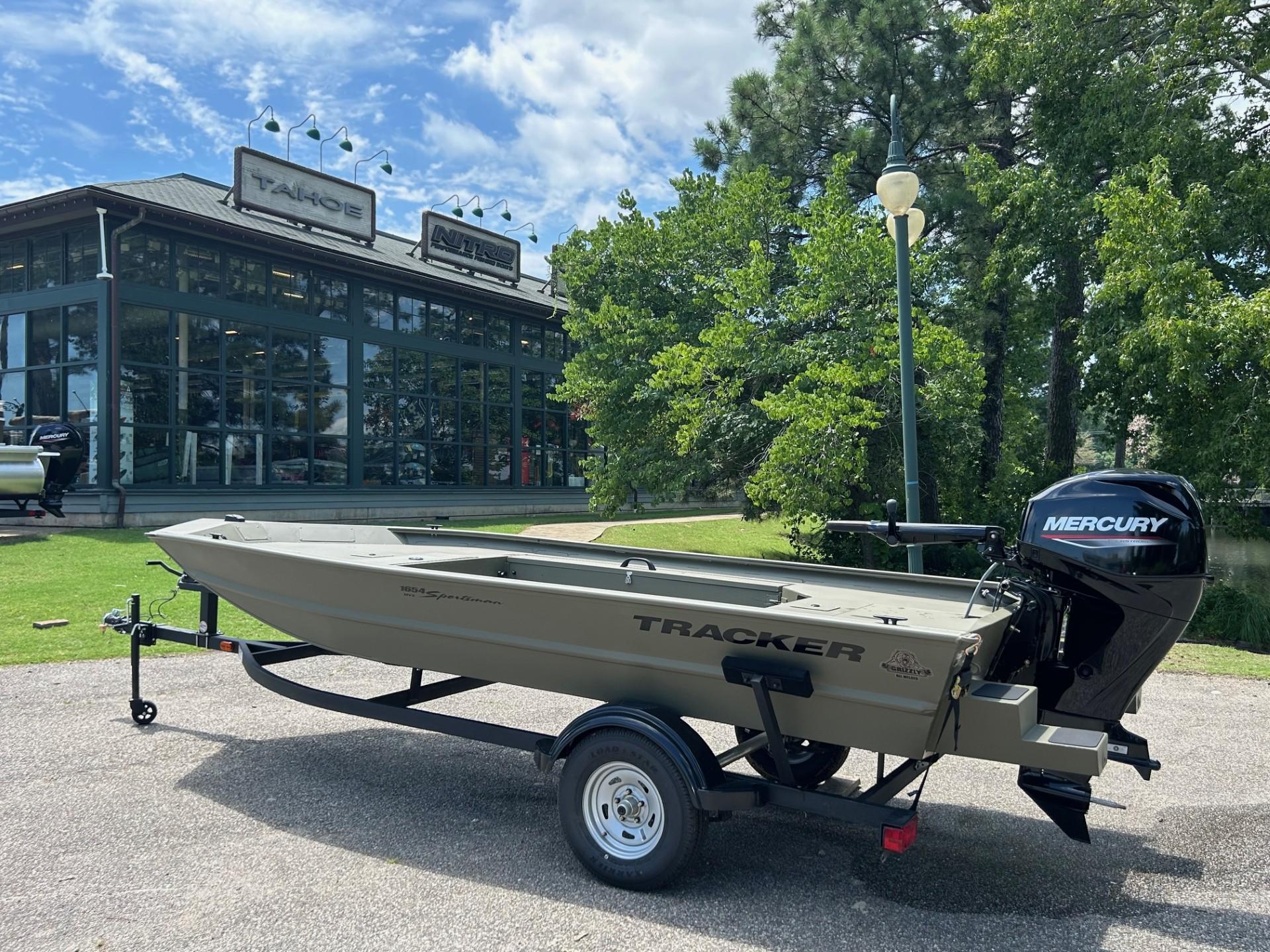 Tracker Grizzly 1654 T Sportsman 2025 Tracker Grizzly 1654 T Sportsman boat with Mercury engine outside dealership.