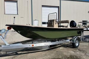 Carolina Skiff E18 JVX CC 2026 Carolina Skiff E18 JVX CC boat on trailer, parked outside a warehouse.