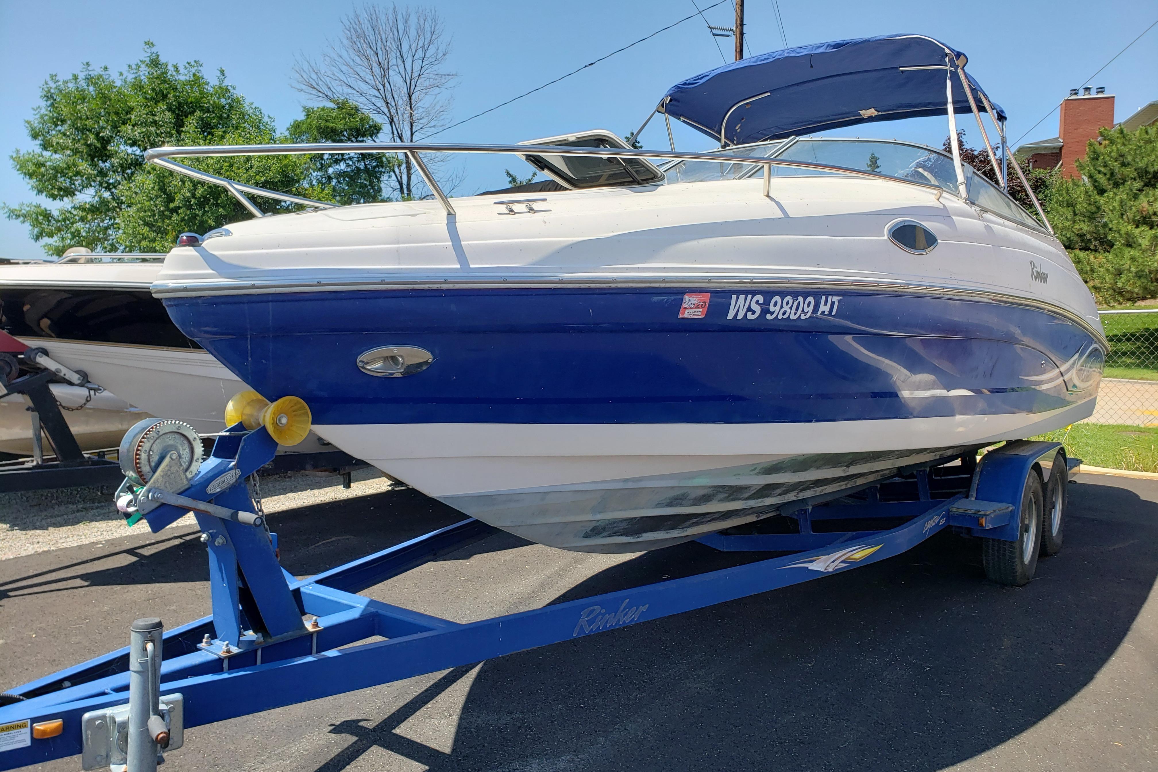 Rinker 232 Captiva Cuddy 2005 Rinker 232 Captiva Cuddy boat on trailer, blue and white exterior.