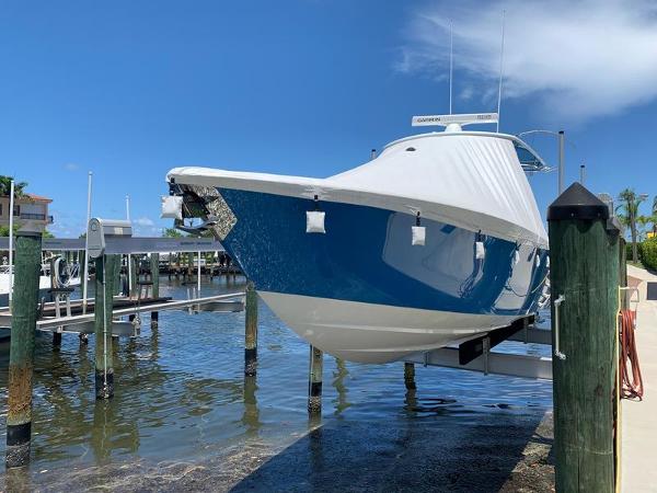 Contender 35 ST 2021 Contender 35 ST boat on lift, blue hull, sunny day, marina background.