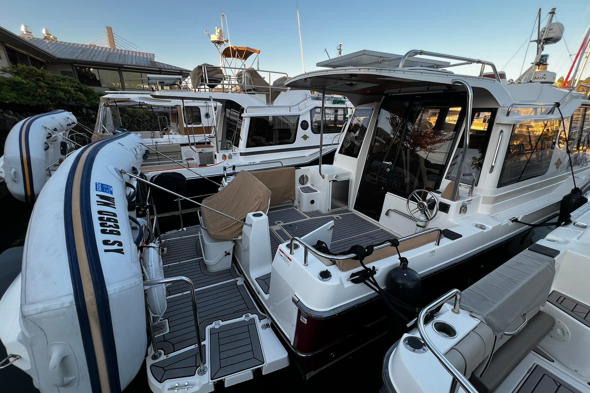 Ranger Tugs R-29S 2021 Ranger Tugs R-29S docked, featuring spacious deck and inflatable dinghy.