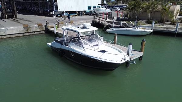 Jeanneau Leader 9.0 WA 2020 Jeanneau Leader 9.0 WA boat docked in a marina, surrounded by calm water.