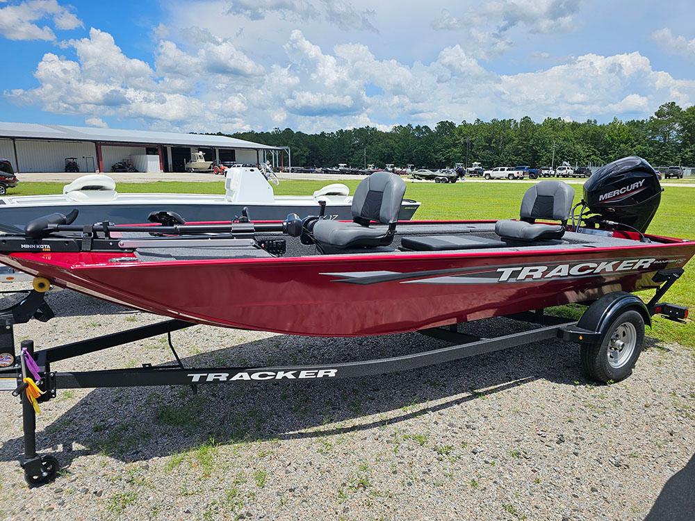 Tracker Panfish 17 2025 Tracker Panfish 17 boat in red, parked outdoors on a trailer.