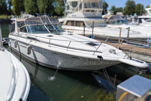 Sea Ray 370 Express Cruiser 1993 Sea Ray 370 Express Cruiser docked at marina, surrounded by other boats.