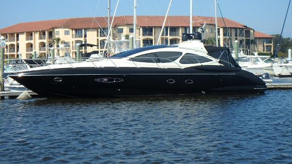 Azimut Atlantis 55 2006 Azimut Atlantis 55 yacht docked in marina, with waterfront buildings in background.