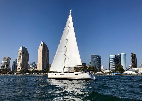 Jeanneau 57 Jeanneau 57 sailboat cruising near city skyline, 2014 model.