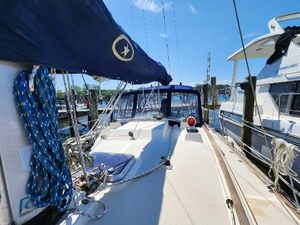 Island Packet 35 Sailboat Island Packet 35, 1991 model, docked at marina under clear blue sky.