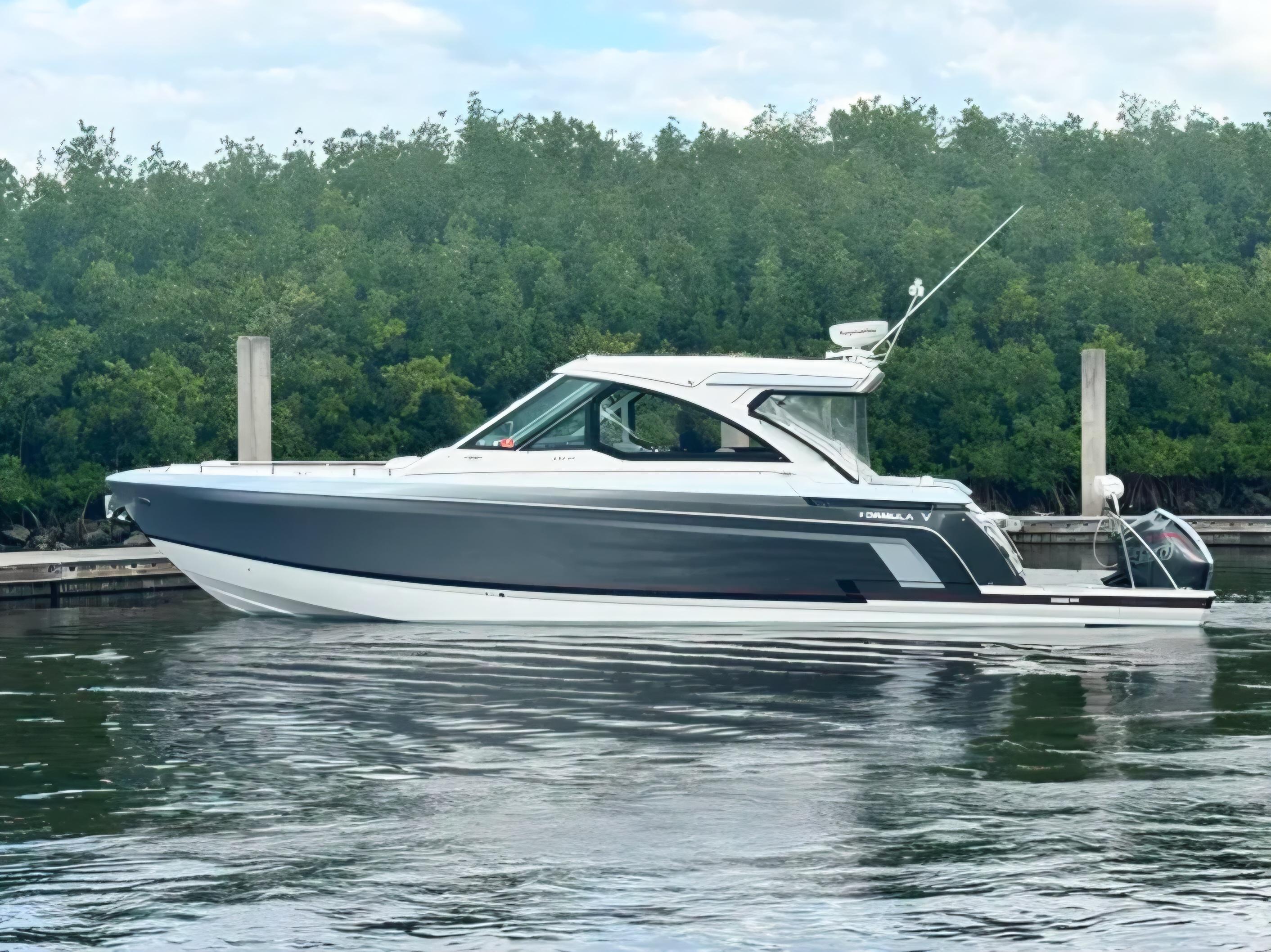 Formula 380 Super Sport Crossover OB 2021 Formula 380 Super Sport Crossover OB boat docked by lush greenery.