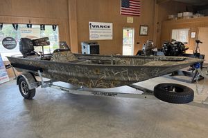 War Eagle 648 Ldsv 2025 War Eagle 648 LDSV boat with camouflage design on a trailer in a showroom.