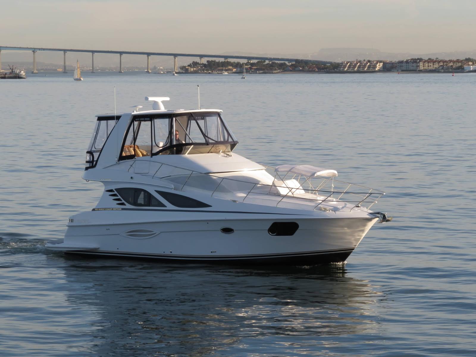 Silverton West Coast Edition 2012 Silverton West Coast Edition yacht cruising on calm waters near a bridge.