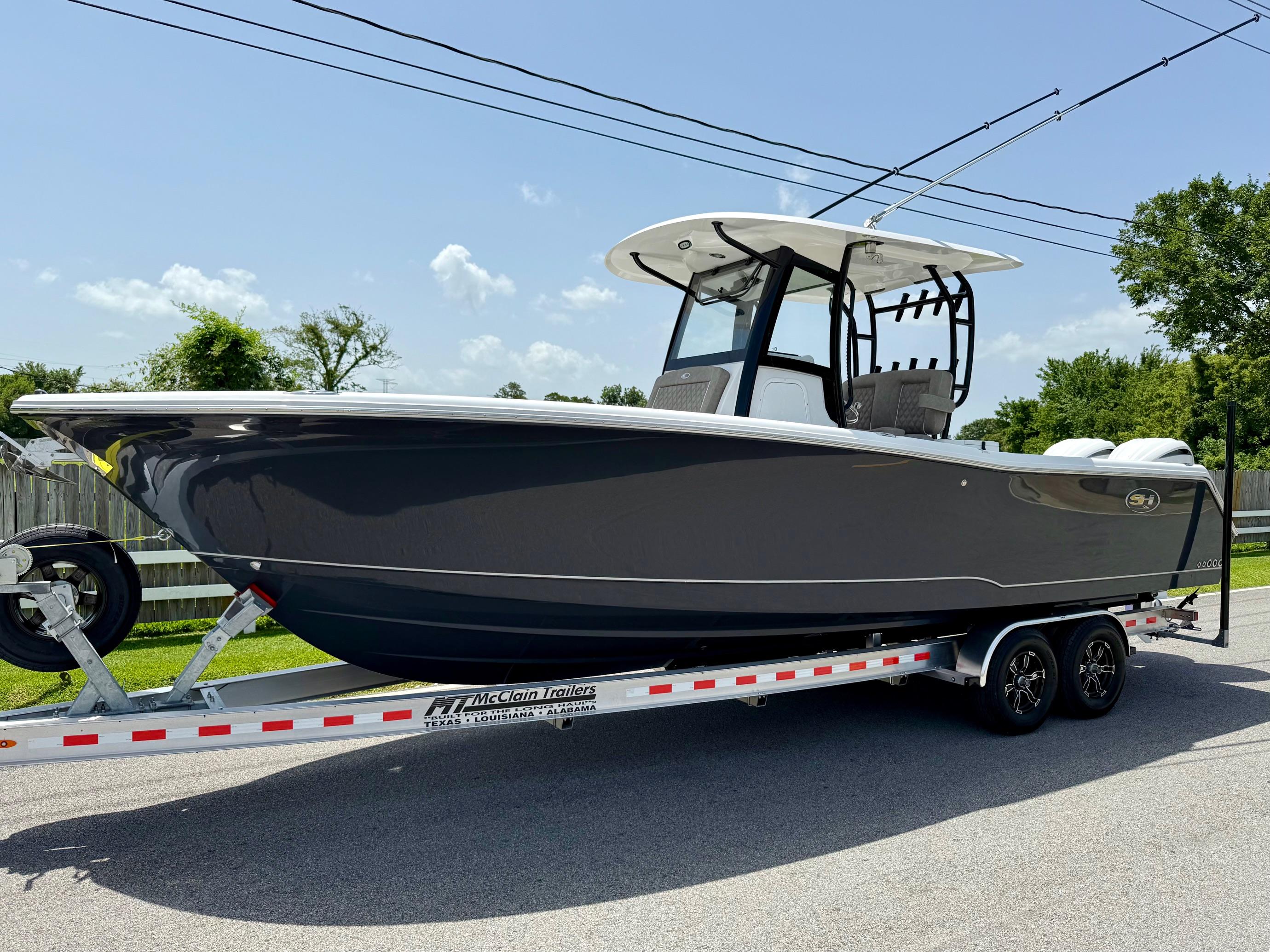 Sea Hunt Gamefish 28 Coffin Box 2026 Sea Hunt Gamefish 28 Coffin Box boat on trailer, parked on a sunny street.