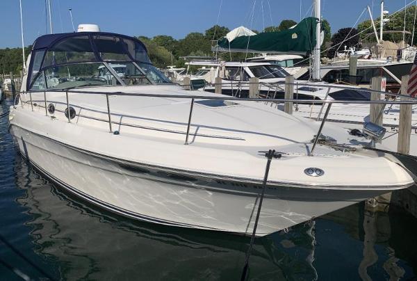 Sea Ray 340 Sundancer 2001 Sea Ray 340 Sundancer docked at marina, sleek white design, calm water.