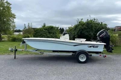 Mako Pro Skiff 15 CC 2025 Mako Pro Skiff 15 CC boat on trailer, parked outdoors.