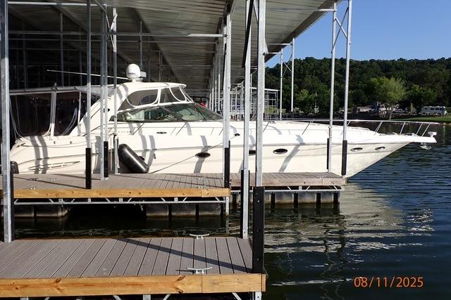 Sea Ray 460 Sundancer 2003 Sea Ray 460 Sundancer yacht docked at marina under clear blue sky.