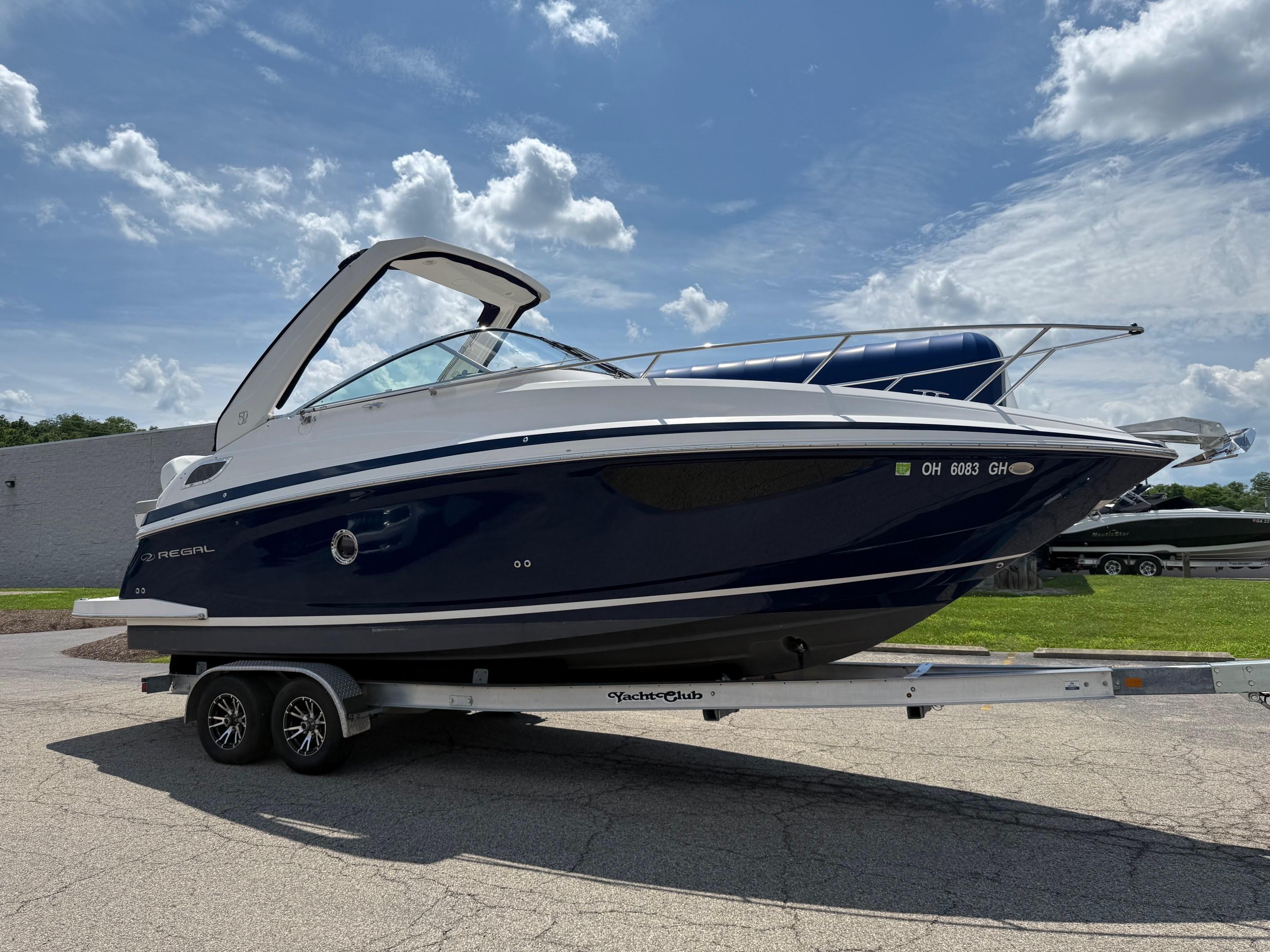 Regal 28 Express 2021 Regal 28 Express boat on trailer under a blue sky.