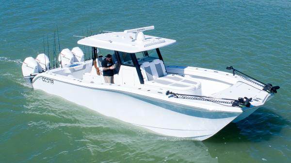 Costa Custom Boats 34SV 2024 Costa Custom Boats 34SV cruising on water, featuring sleek design and multiple outboard engines.